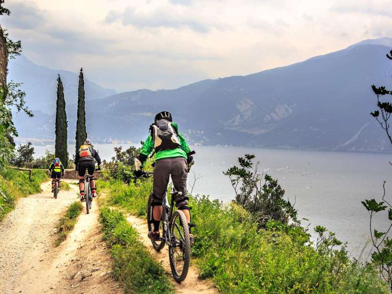 Mensen aan het mountainbiken met het Gardameer op de achtergrond